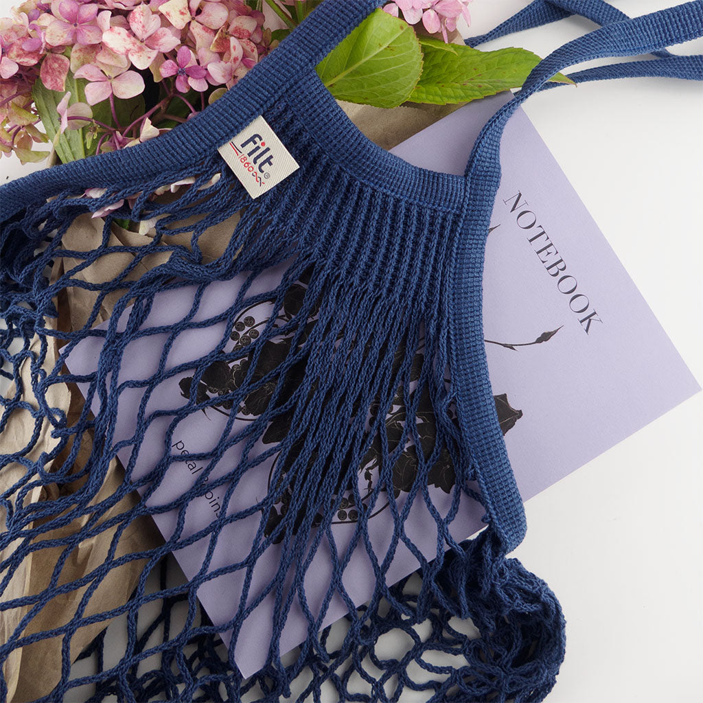 filt string bag in ink styled with a petal & pins notebook and hydrangea flowers