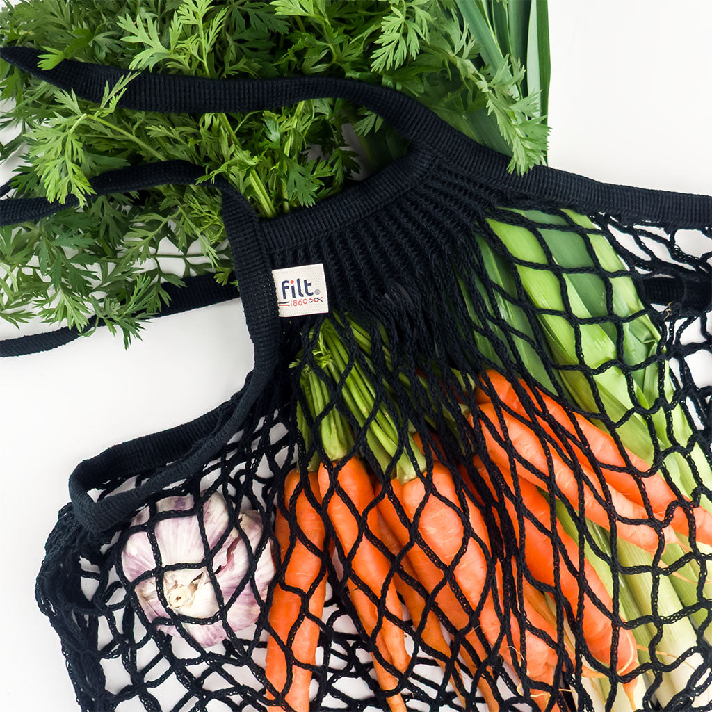 filt string bag in noir styled with carrots and celery
