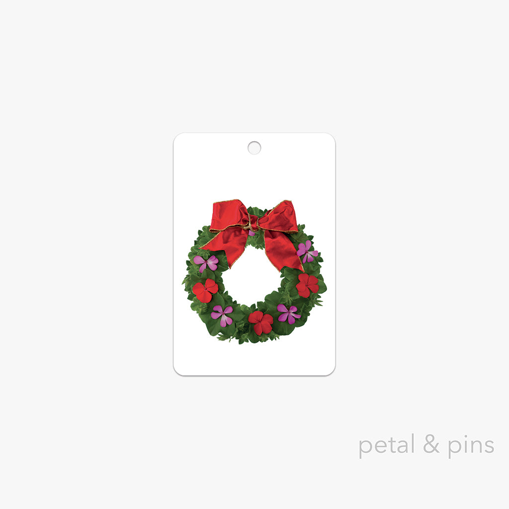 Christmas wreath with red ribbon on a white card, by petal & pins.