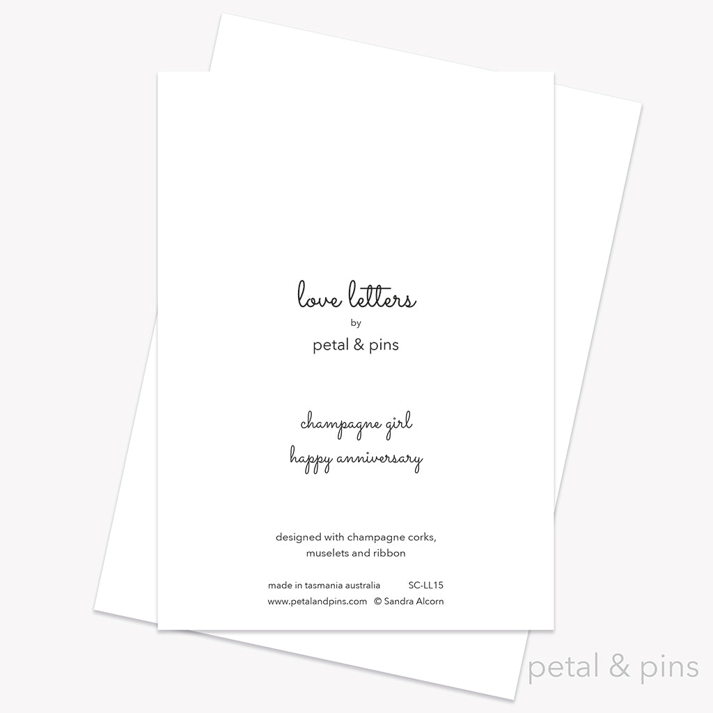 Happy Anniversary Card back from the Love Letters collection by petal & pins. Card with two cork characters with the greeting 'Happy Anniversary', on a white background.