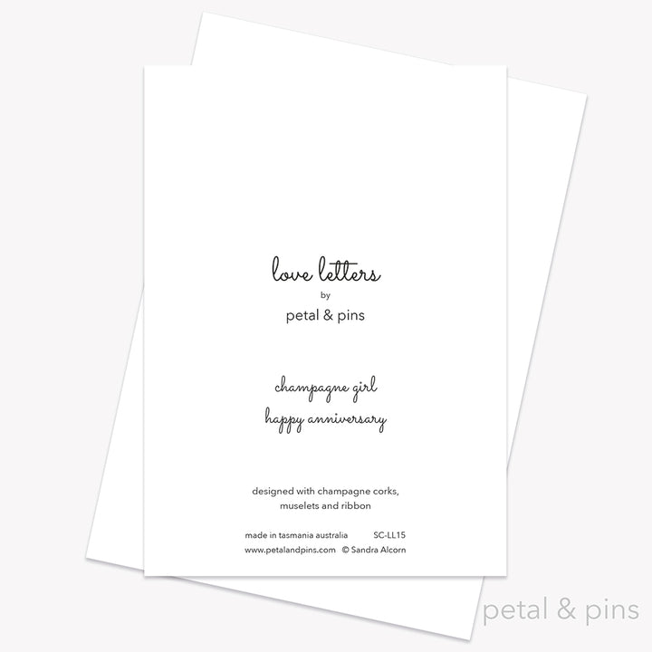 Happy Anniversary Card back from the Love Letters collection by petal & pins. Card with two cork characters with the greeting 'Happy Anniversary', on a white background.