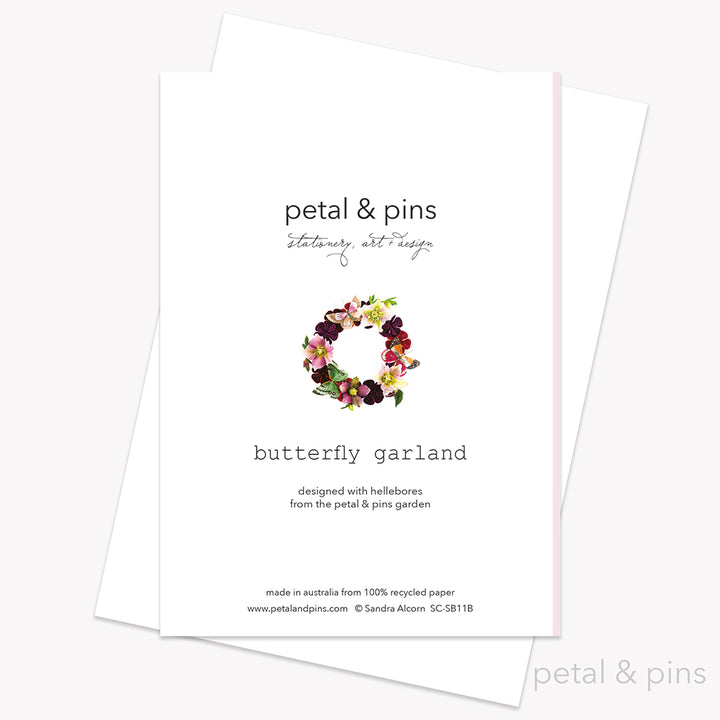 Butterfly Garland (Rosewater) card back by petal & pins. Greeting card with floral and butterfly design on a pink background.