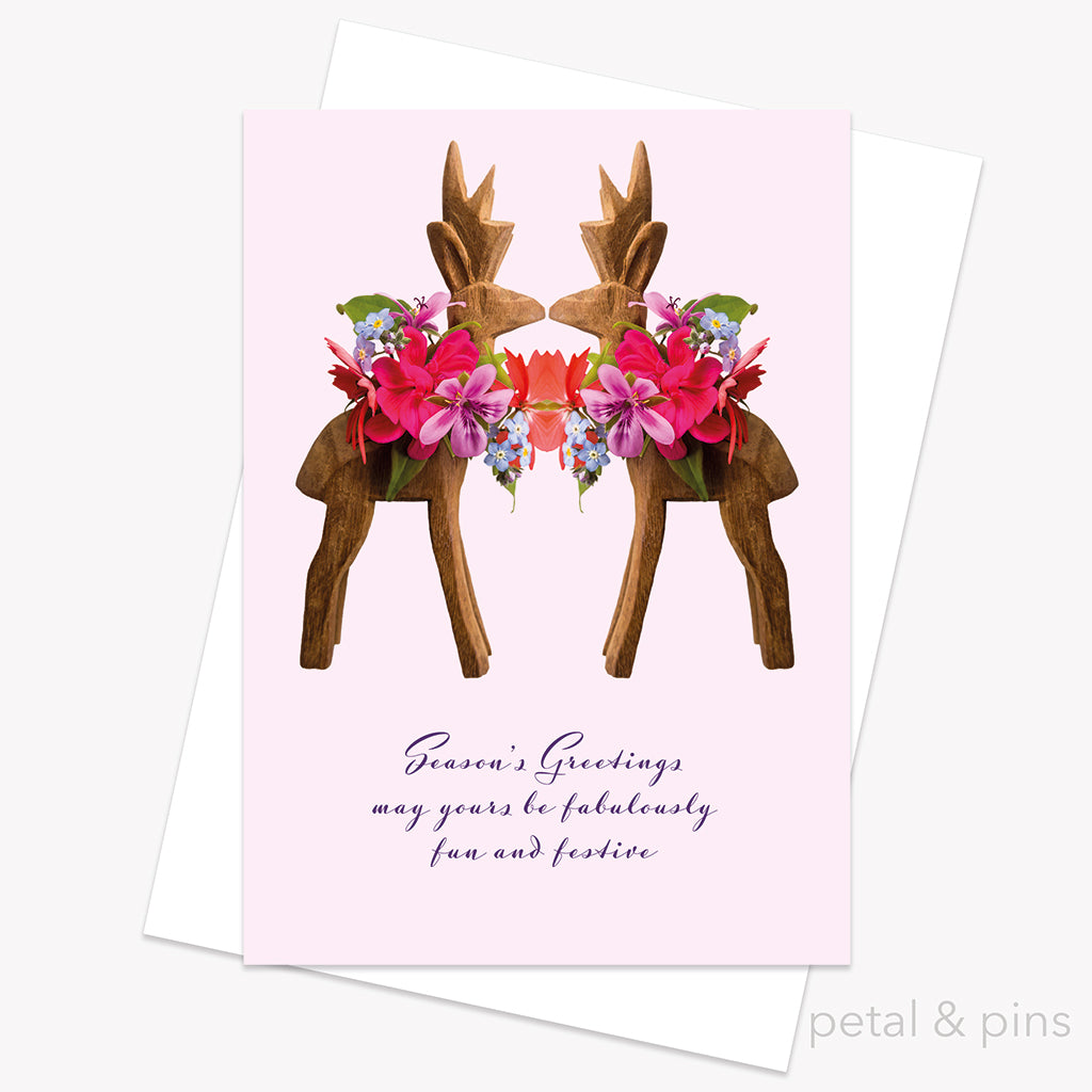 Greeting card with floral reindeer design and 'Season's Greetings' text on a pink background by petal & pins.