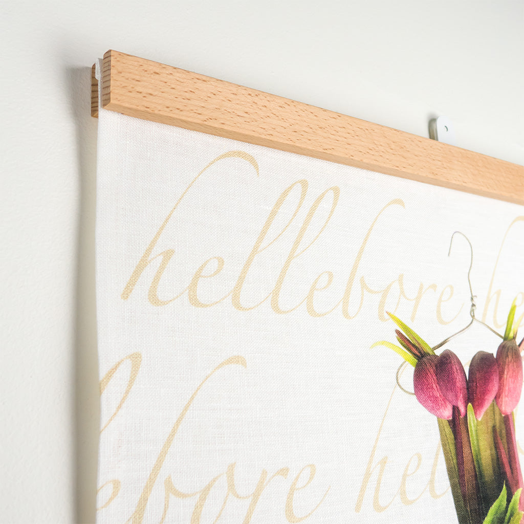 close up of fabric hangar in beech by made by good deeds displayed with crimson hellebore tea towel by petal & pins