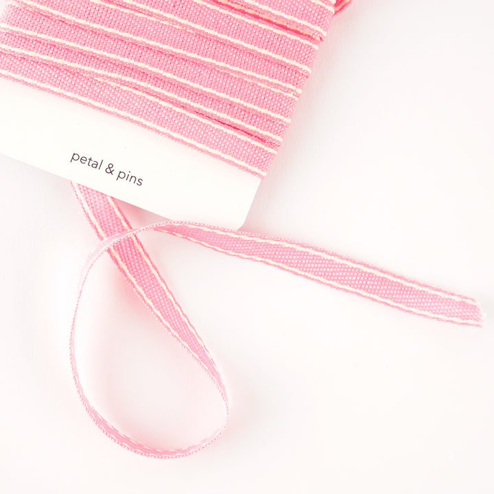 ribbon on card slightly unwound - stitched woven cotton - pink