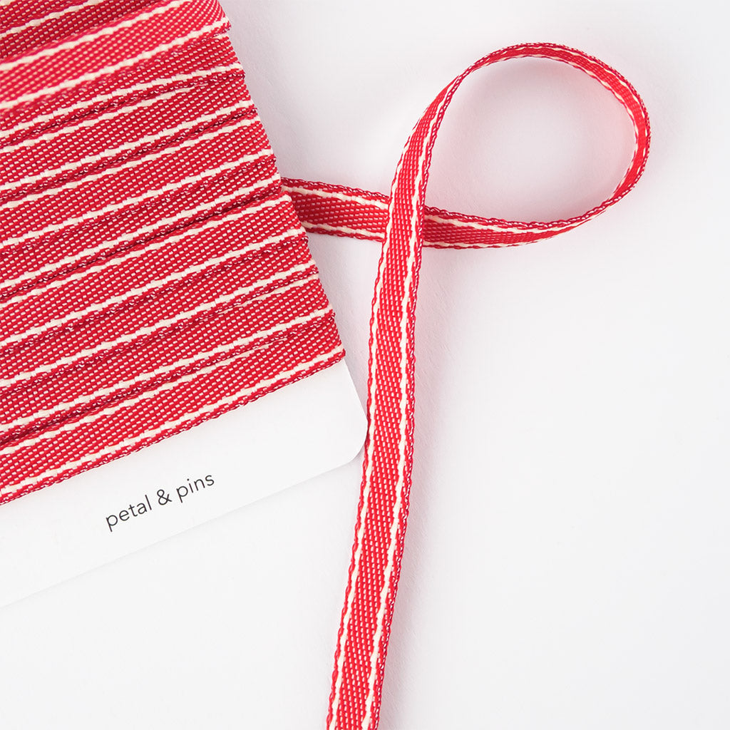 ribbon on card slightly unwound - stitched woven cotton - red